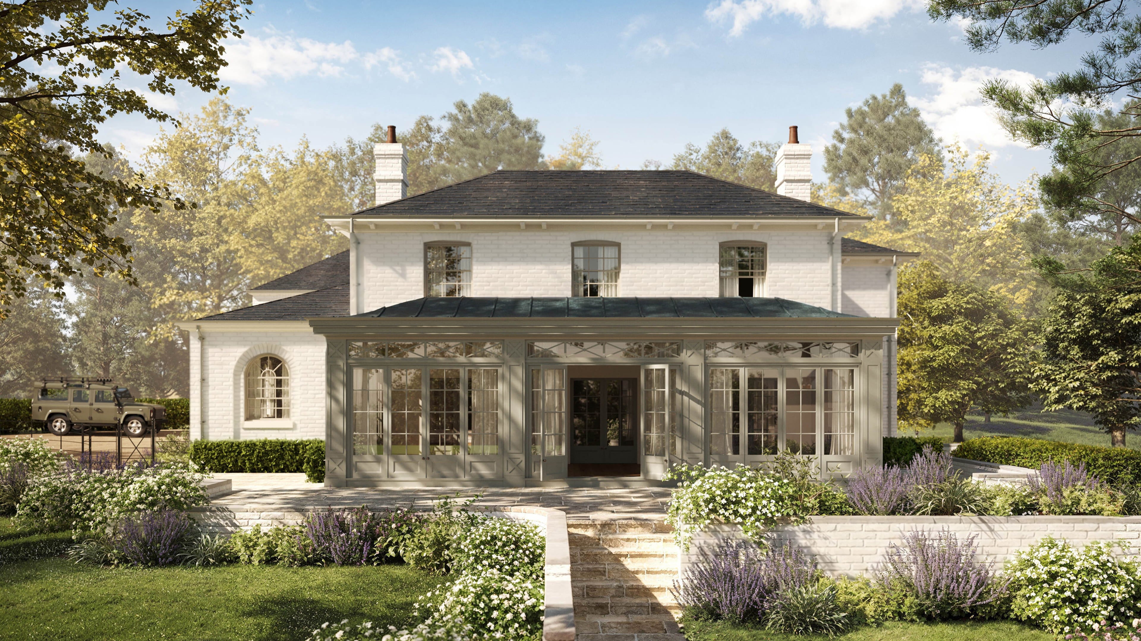 Elegant white brick house with a slate roof, large glass conservatory, and manicured gardens featuring lavender and white roses