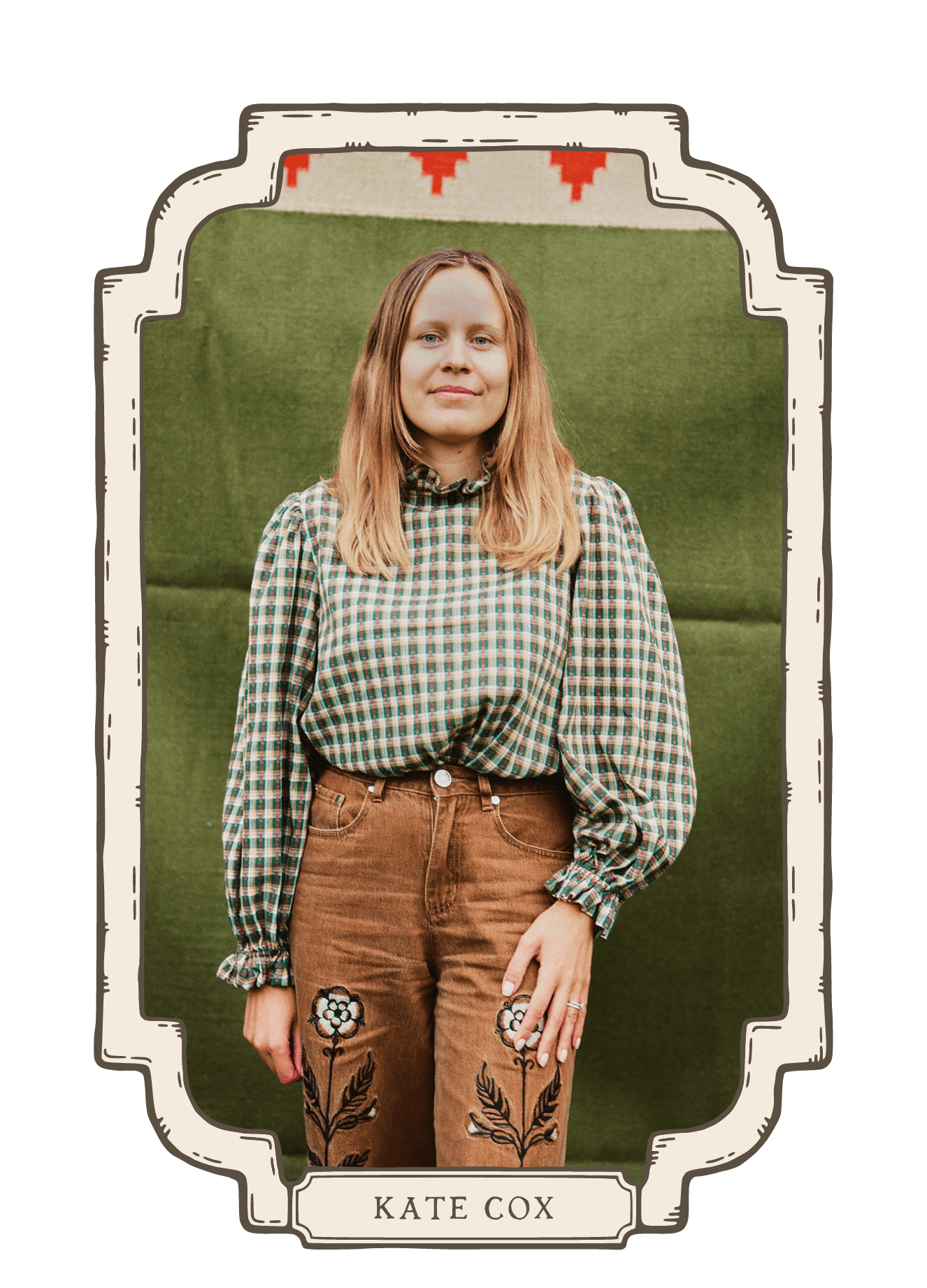 Portrait of a woman with long hair wearing a green checkered blouse and brown embroidered trousers against a textured green backdrop
