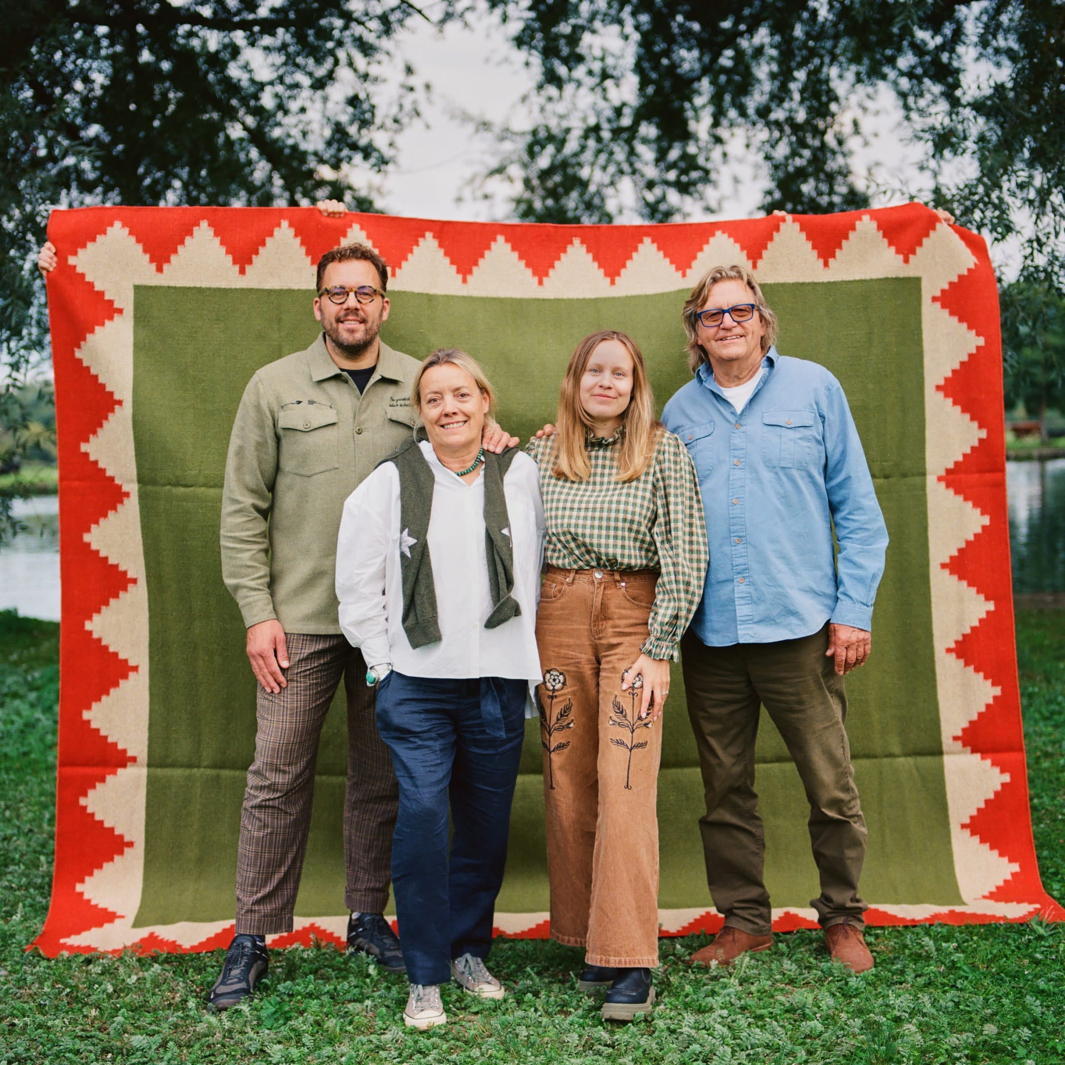 The family standing in font of a Studio Ham rug