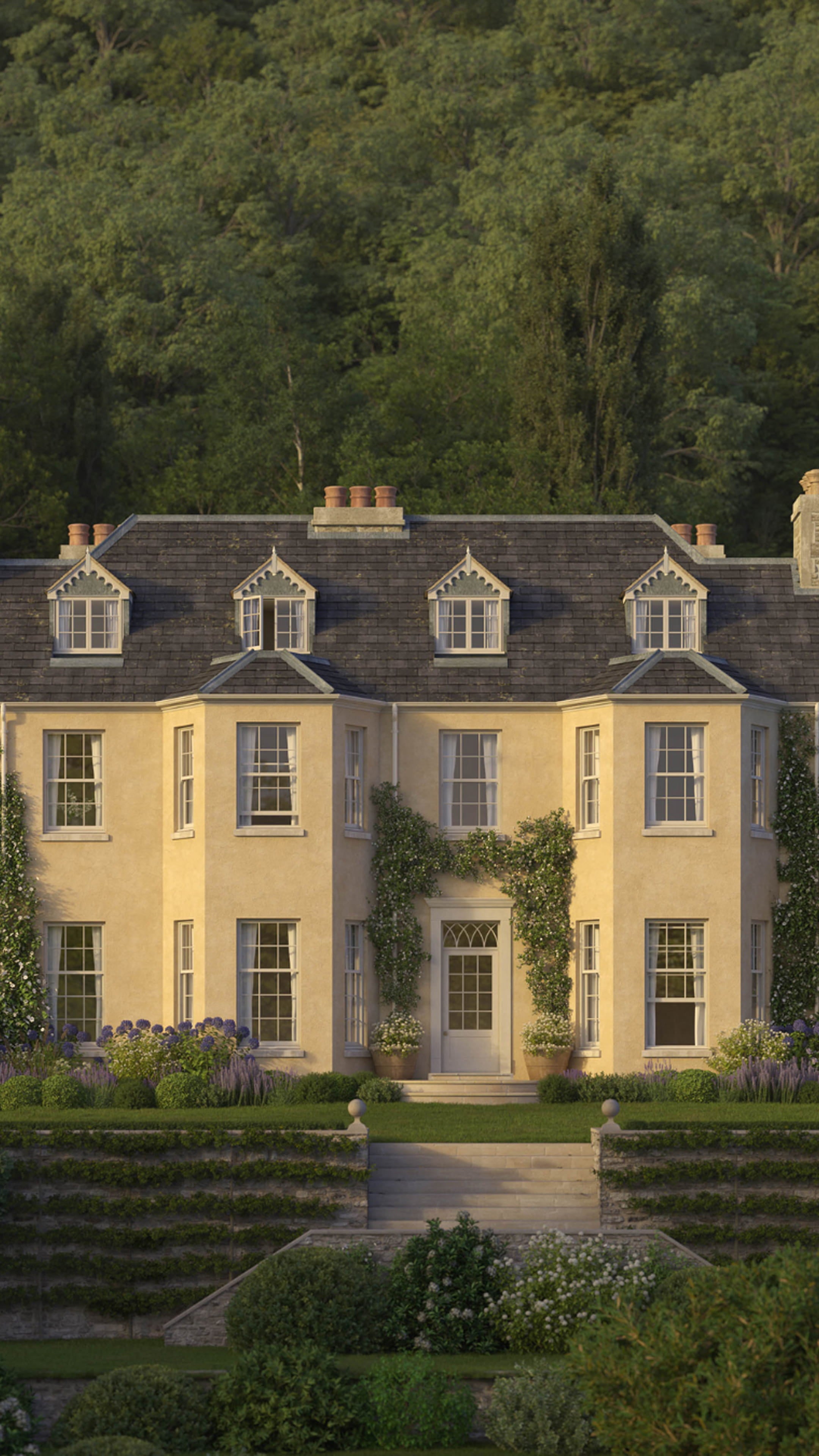 Georgian-style house with pale yellow render, slate roof, intricate gabled windows, and lush greenery surrounding the entrance