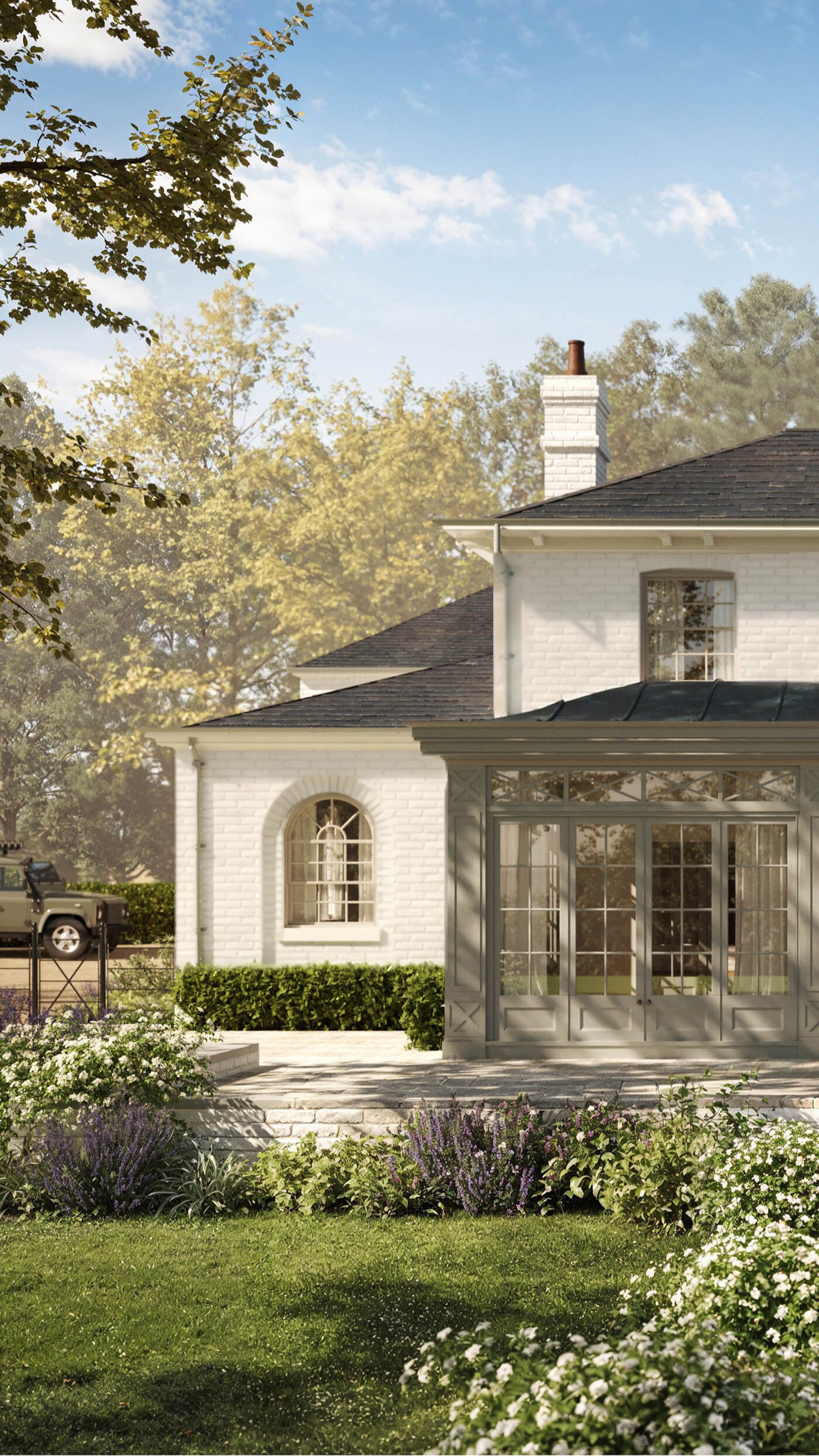 Elegant white brick house with a slate roof, large glass conservatory, and manicured gardens featuring lavender and white roses